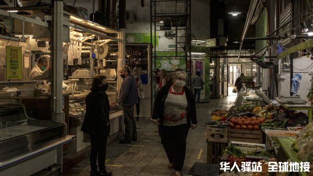 shoppers-wearing-protective-masks-walk-through-a-market-in-the-caballito-neighbo.jpg